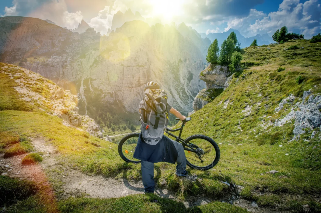 Cyclist looking at the view of Dolomite mountains.