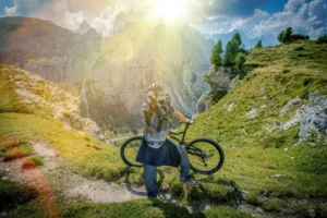 Cyclist looking at the view of Dolomite mountains.