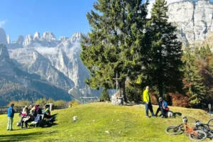 Cyclists and Hikers with view of Brenta Dolomites.