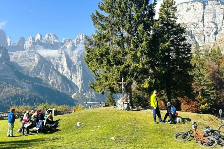 Cyclists and Hikers with view of Brenta Dolomites.