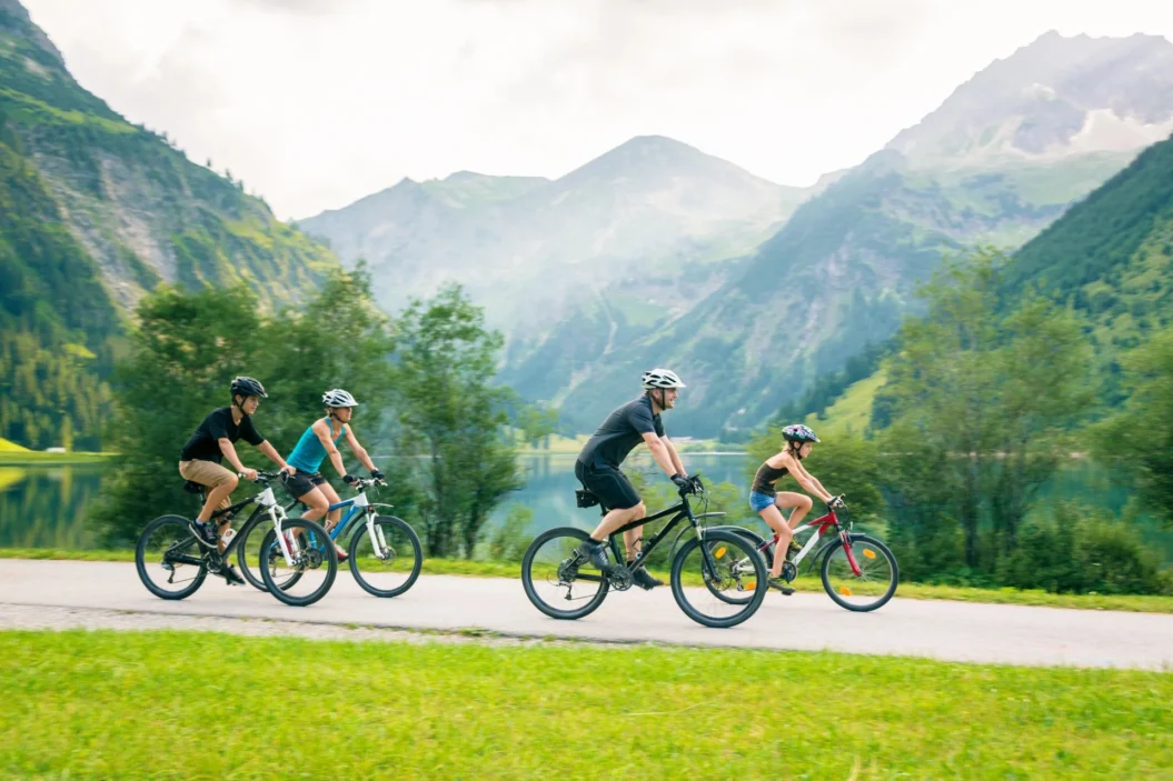 Family cycling on cycle path in the mountains.
