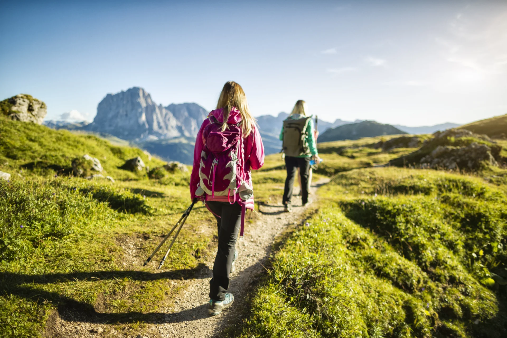 Two hikers on a trail in South Tyrol Italy.