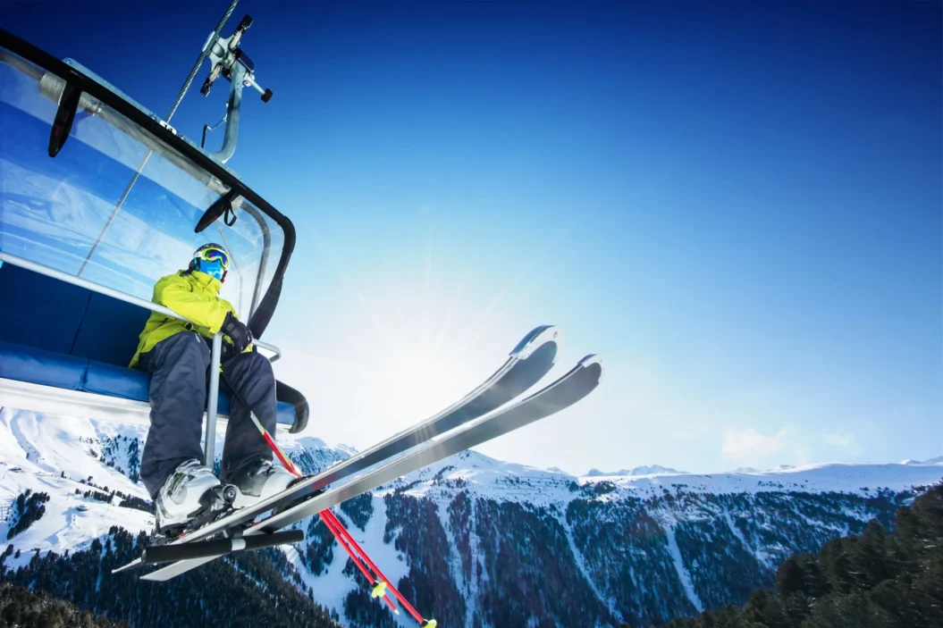 Skier on chairlift in mountains