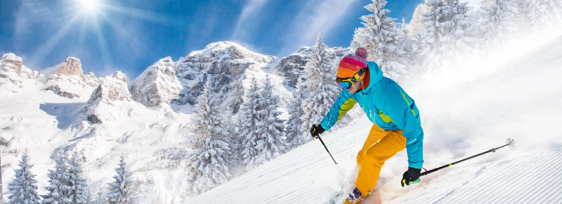 Skier on freshly groomed slopes in high mountains