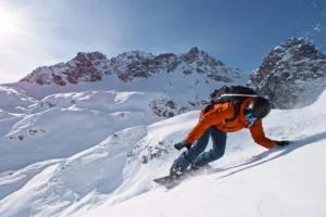 Snowboarder in fresh powder on a sunny day