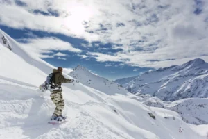 Snowboarder - Traversing on a perfect day in the Italian Alps.