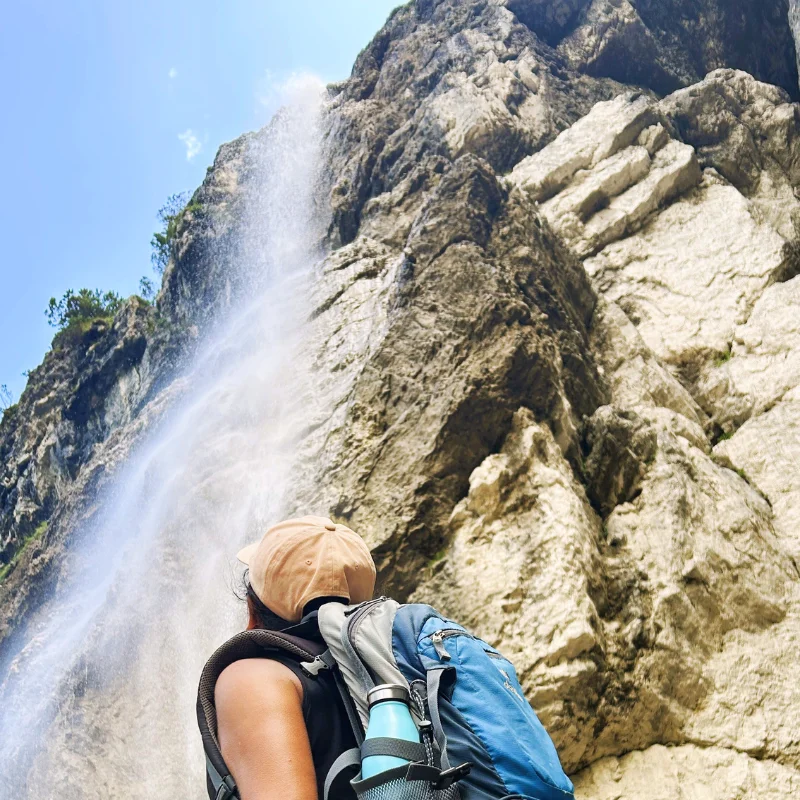 Lucille admiring a waterfall at Lago di Tovel Brenta Dolomites.