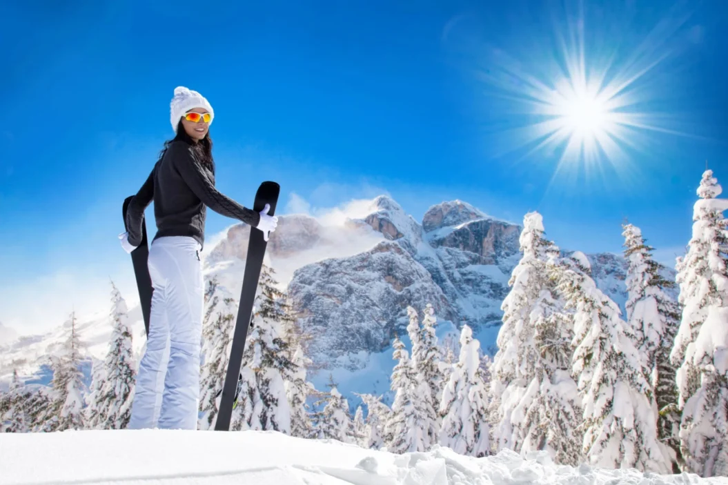 Female skier with pretty mountain backdrop.
