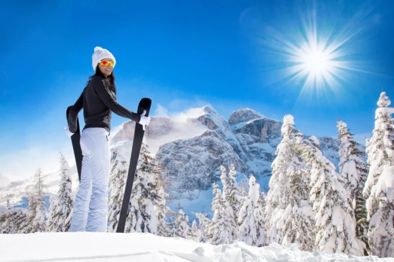 Female skier with pretty mountain backdrop.