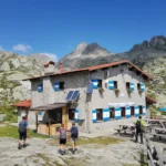Hikers arriving and relaxing at Rifugio Segantini, Madonna di Campiglio in the Brenta Dolomites.