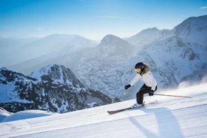 Skier with mountain backdrop.
