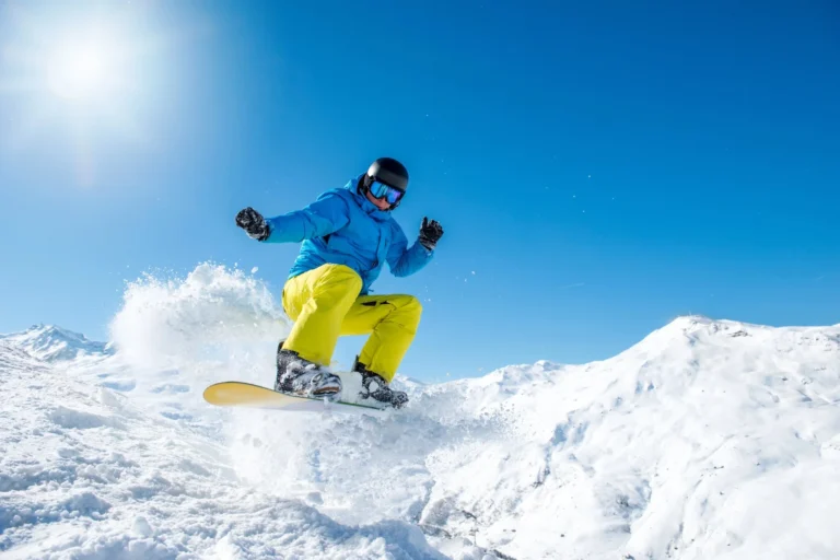 Snowboarder jumping in powdery snow.