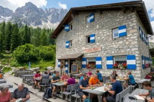 Hikers eating lunch at Rifugio Vandelli at Lago di Sorapis.