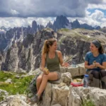 Two female friends with a picnic lunch in the mountains.